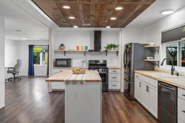 a kitchen with refrigerator and cabinets