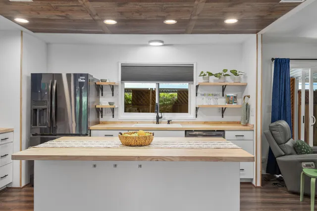a kitchen with a refrigerator and a stove