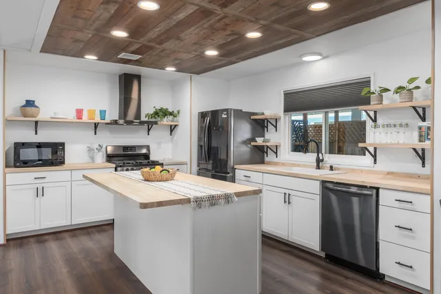 a kitchen that has a sink and a stove in it
