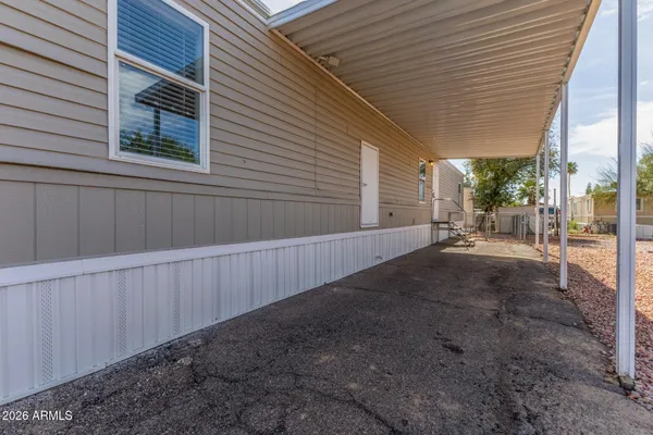 a view of a pathway of a house with wooden fence