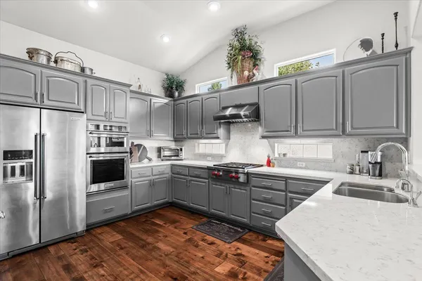 a kitchen with cabinets and steel stainless steel appliances