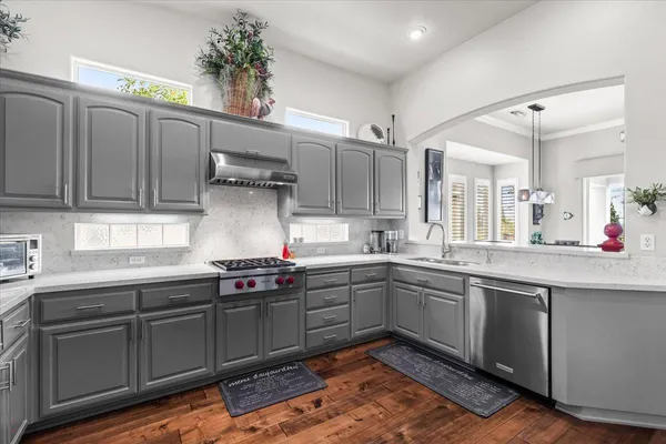 a kitchen with stainless steel appliances granite countertop a sink and cabinets