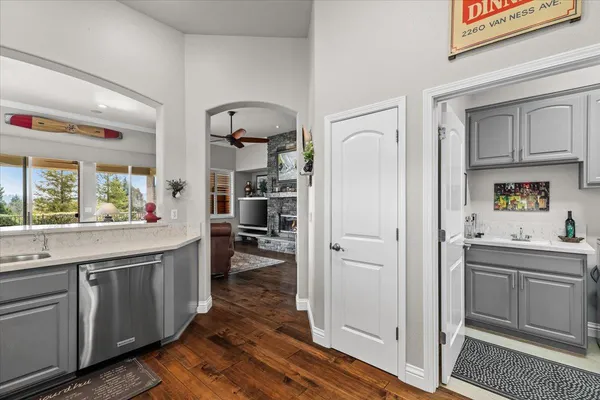 a utility room with stainless steel appliances white cabinets and a sink