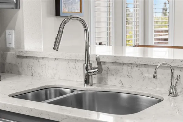 a spacious bedroom with a bed a couch and a large window