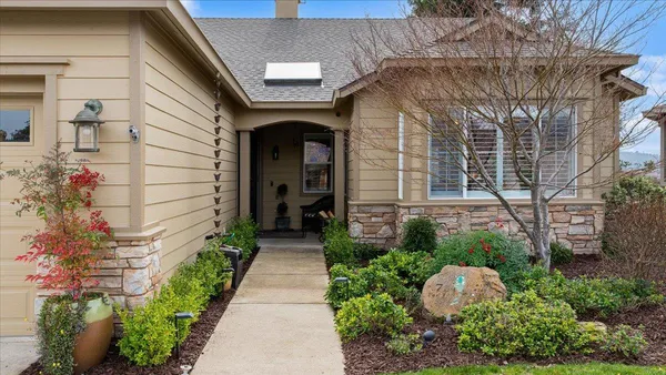 a front view of a house with a garden