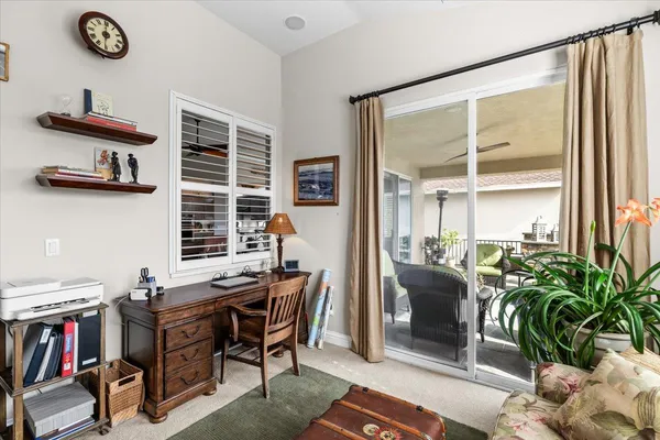 a front view of a house with a yard and a trees