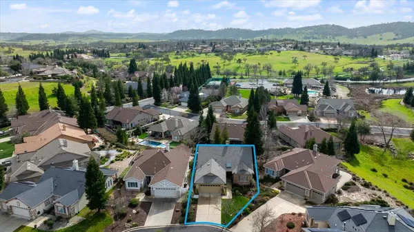 a view of a swimming pool with a patio and a yard