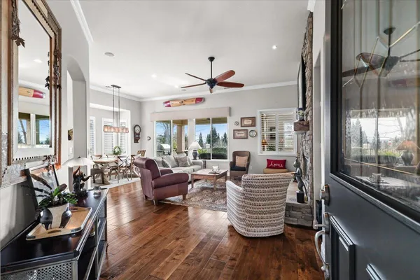 a living room with furniture a flat screen tv and a fireplace