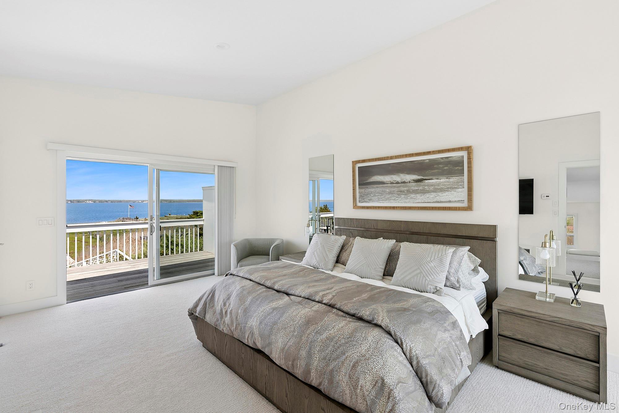 588 Dune Road Westhampton, NY 11978 - Photo 9 of 23 a bed room with a bed and a large window