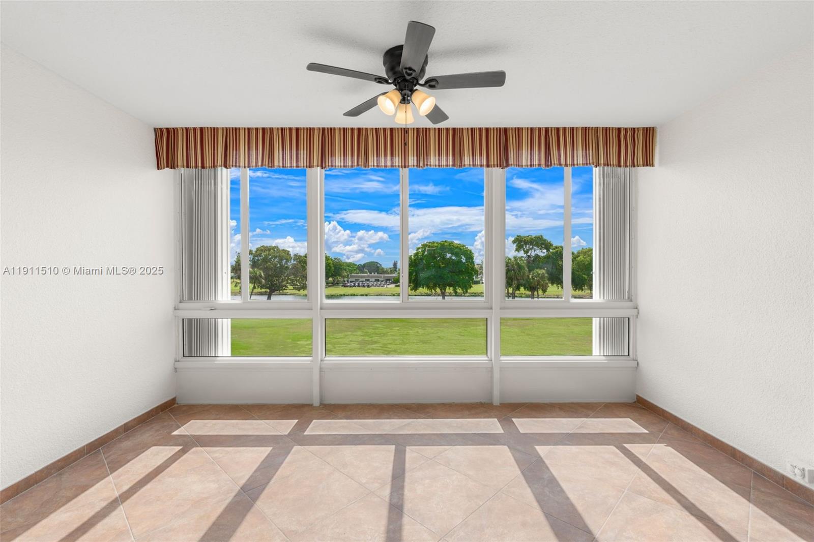 7640 Northwest 18th Street, Unit 301 Margate, FL 33063 - Photo 12 of 35 a view of a room with a window and a ceiling fan