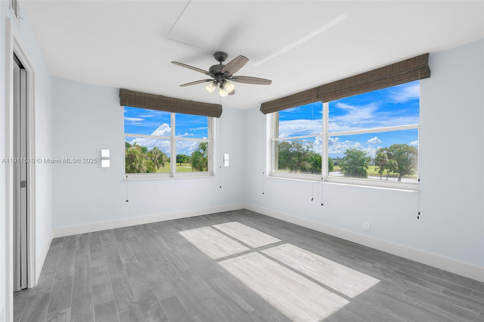 7640 Northwest 18th Street, Unit 301 Margate, FL 33063 - Photo 14 of 35 a view of empty room with wooden floor and fan