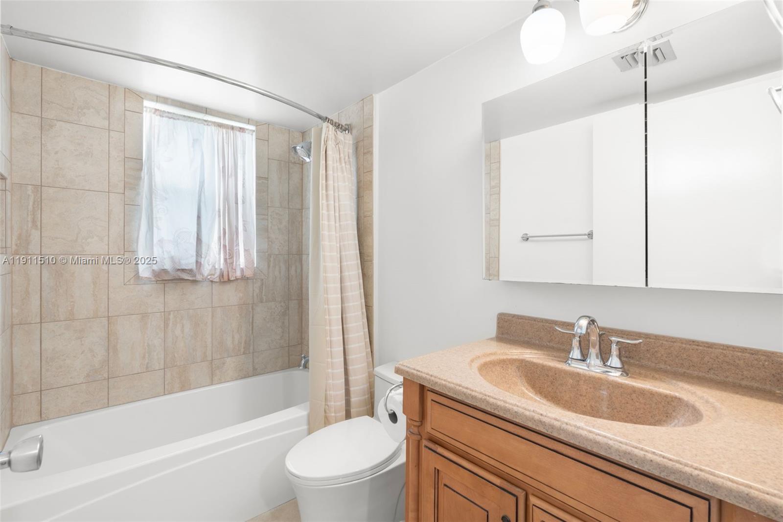 7640 Northwest 18th Street, Unit 301 Margate, FL 33063 - Photo 20 of 35 a bathroom with a sink a toilet and a bathtub