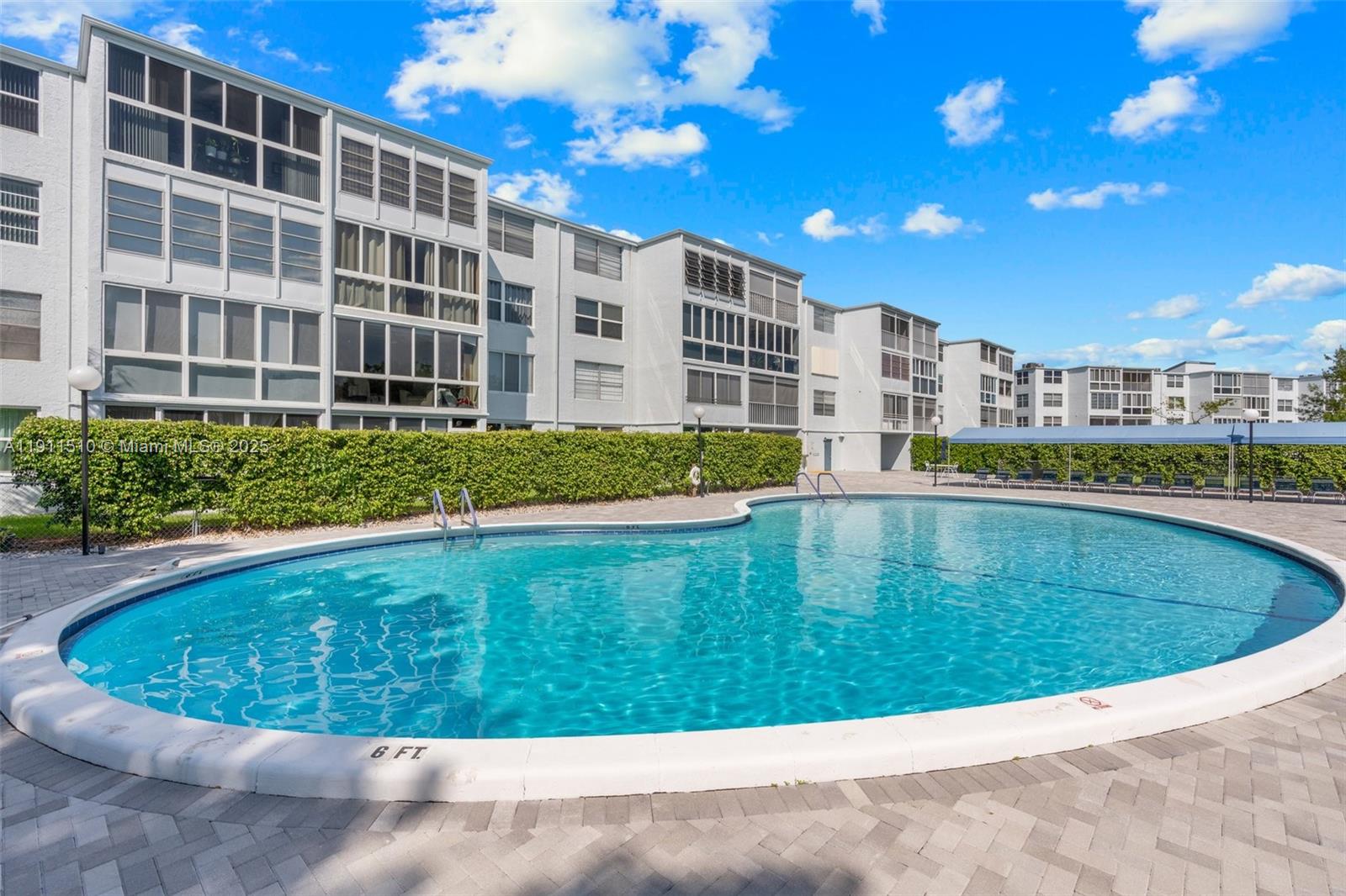 7640 Northwest 18th Street, Unit 301 Margate, FL 33063 - Photo 24 of 35 a view of a swimming pool with a sitting space