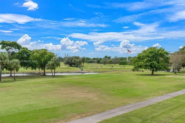 a view of a big yard with a house in the background