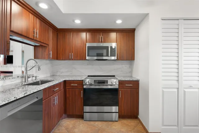 a kitchen with sink a microwave and cabinets