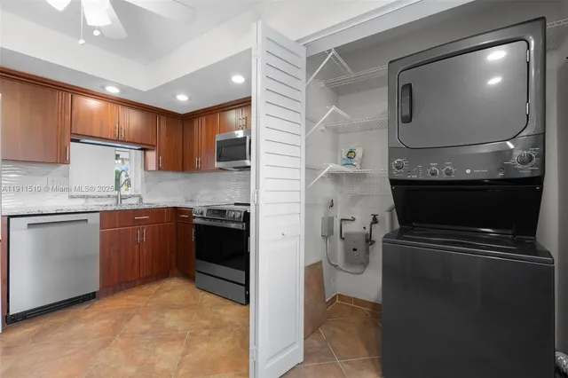 a kitchen with a refrigerator and a stove top oven