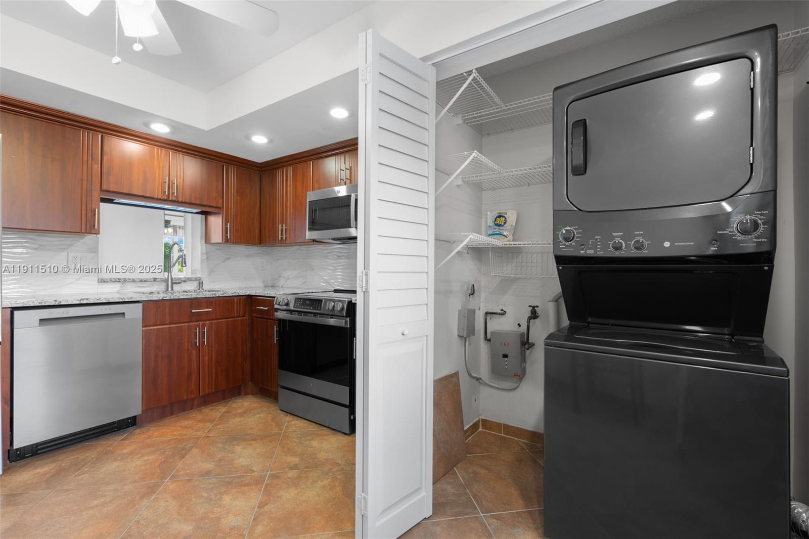 7640 Northwest 18th Street, Unit 301 Margate, FL 33063 - Photo 7 of 35 a kitchen with a refrigerator and a stove top oven