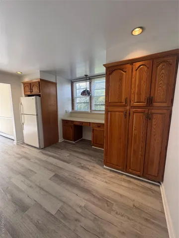 a view of a refrigerator in kitchen and wooden floor