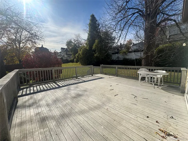 a view of backyard with seating and trees