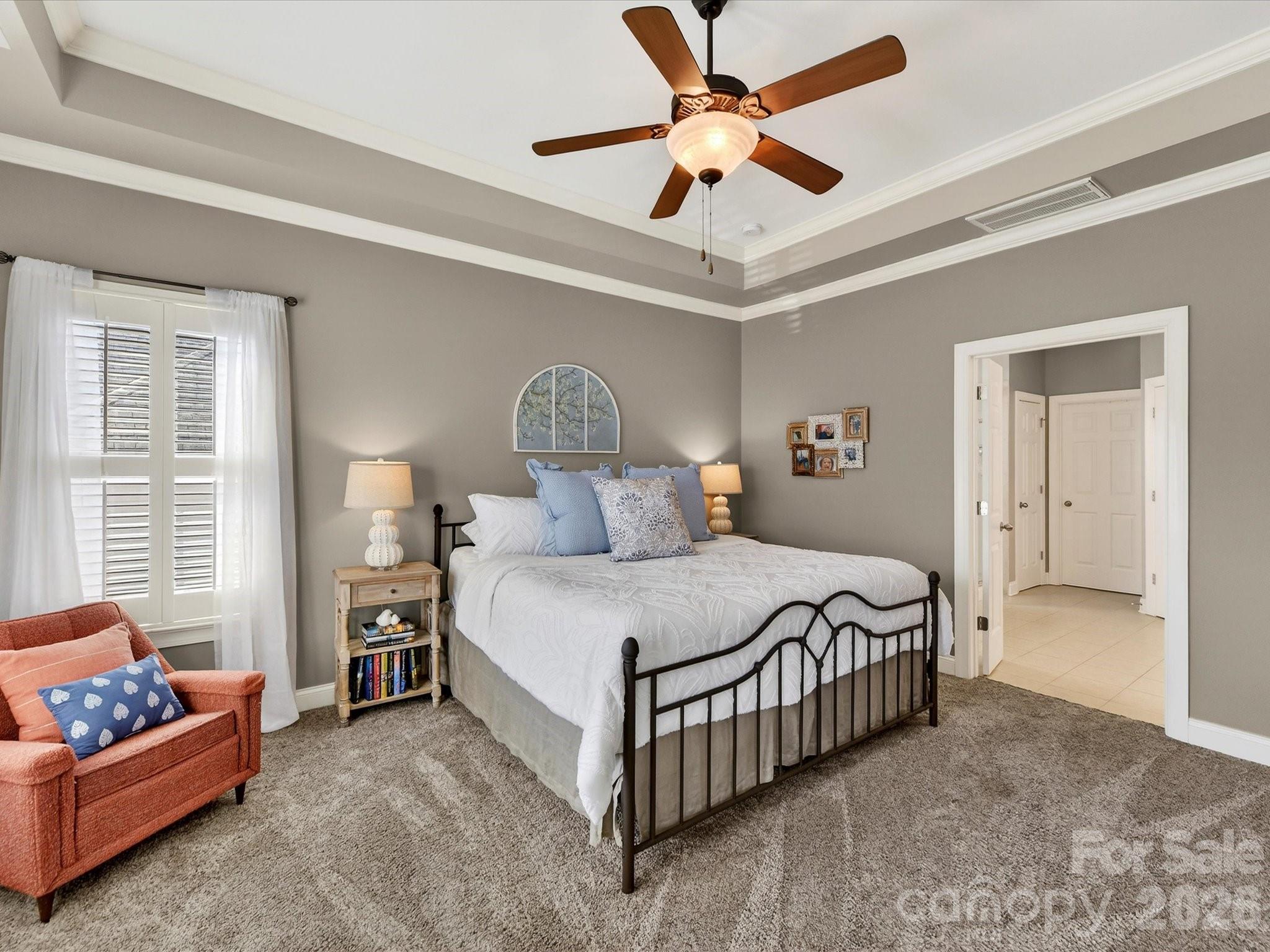 4265 Birkshire Heights Fort Mill, SC 29708 - Photo 25 of 47 a bedroom with a bed chandelier and a window