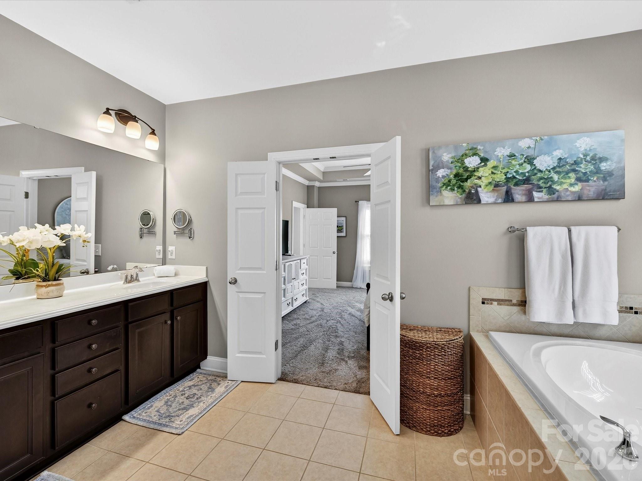 4265 Birkshire Heights Fort Mill, SC 29708 - Photo 30 of 47 a spacious bathroom with a tub sink and mirror