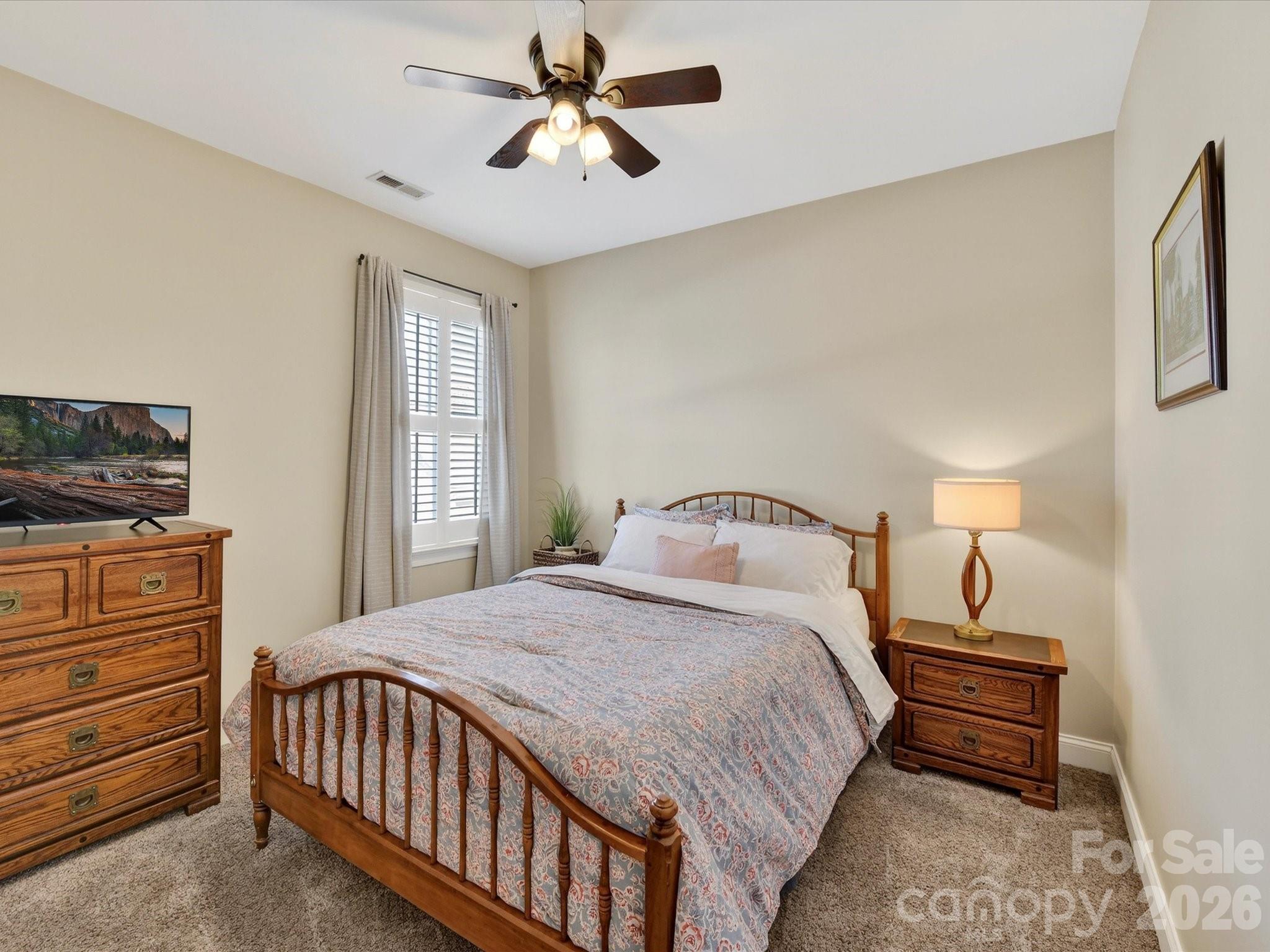 4265 Birkshire Heights Fort Mill, SC 29708 - Photo 31 of 47 a bedroom with a bed a chandelier and a dresser