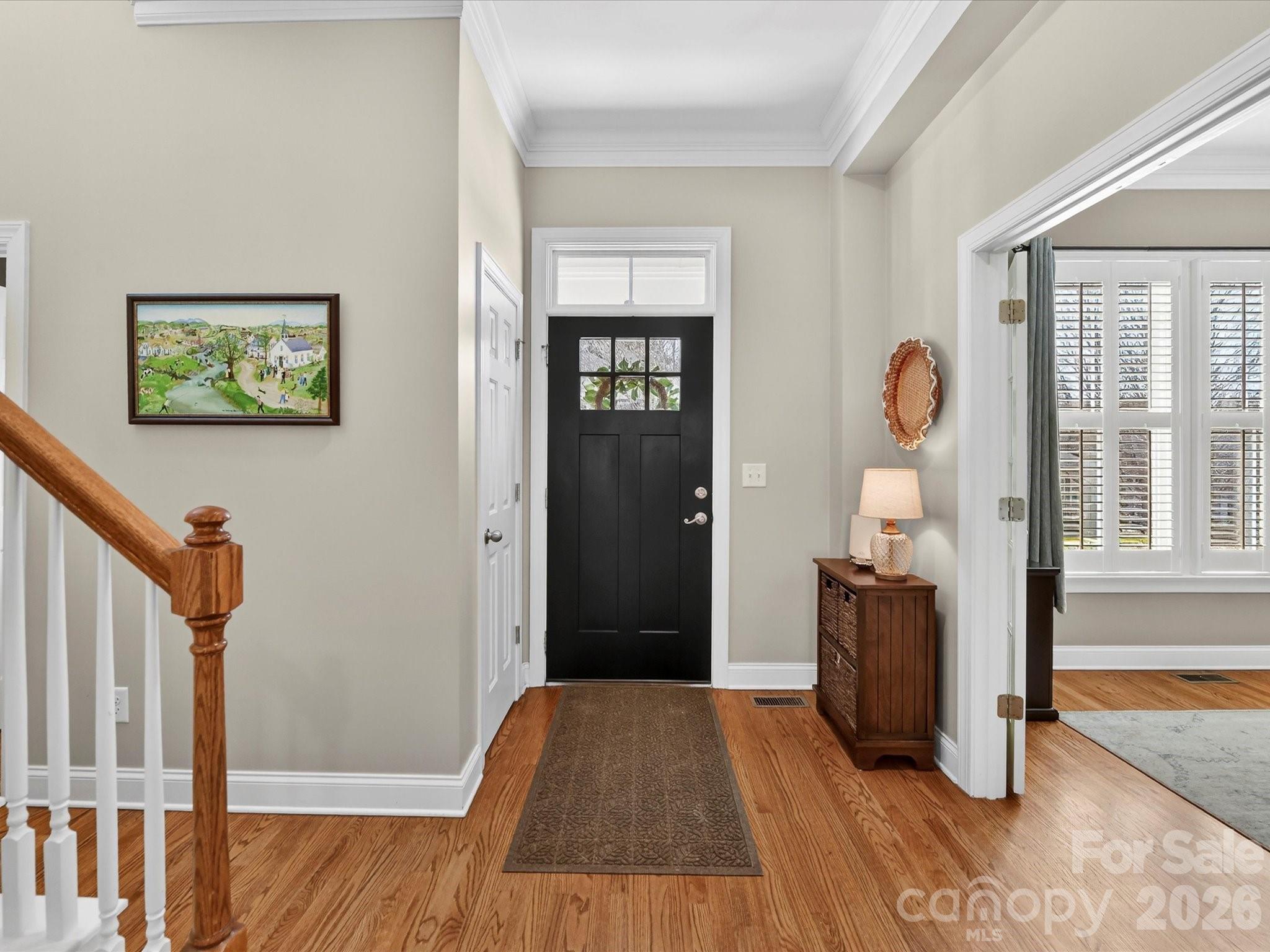 4265 Birkshire Heights Fort Mill, SC 29708 - Photo 7 of 47 a view of a hallway with wooden floor and staircase