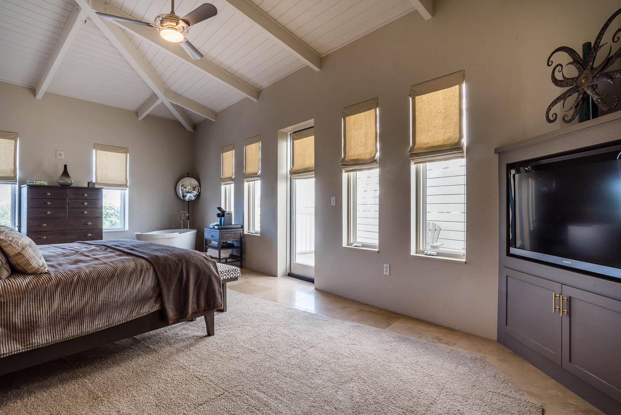 35 Central Square, Unit A2 Santa Rosa Beach, FL 32459 - Photo 18 of 34 a bedroom with a bed and a flat screen tv