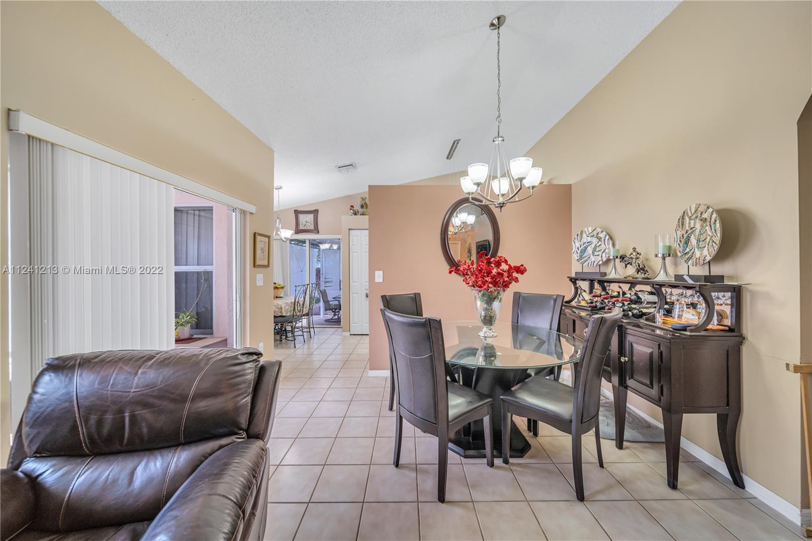 14202 Southwest 151st Court Miami, FL 33196 - Photo 11 of 23 a view of a dining room with furniture and chandelier