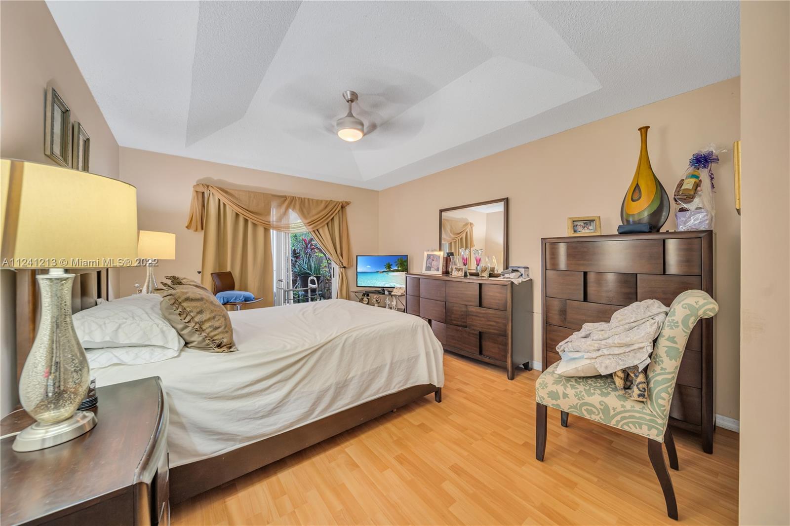 14202 Southwest 151st Court Miami, FL 33196 - Photo 13 of 23 a bedroom with a bed a mirror and window