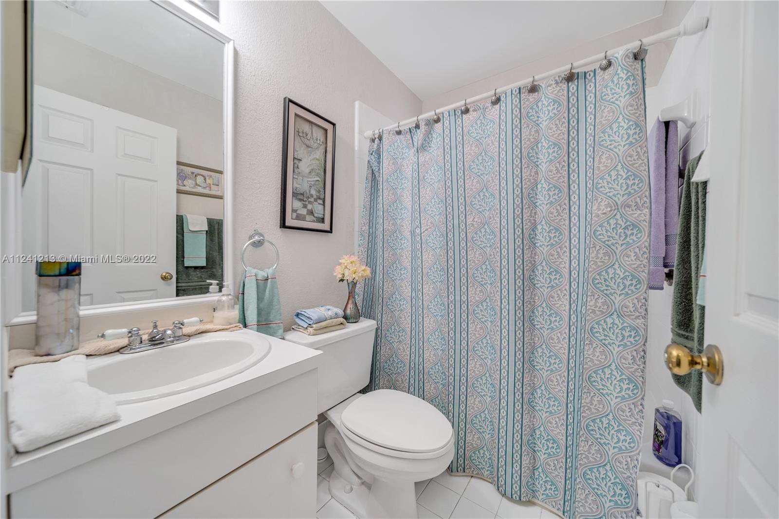 14202 Southwest 151st Court Miami, FL 33196 - Photo 16 of 23 a bathroom with a sink toilet and shower