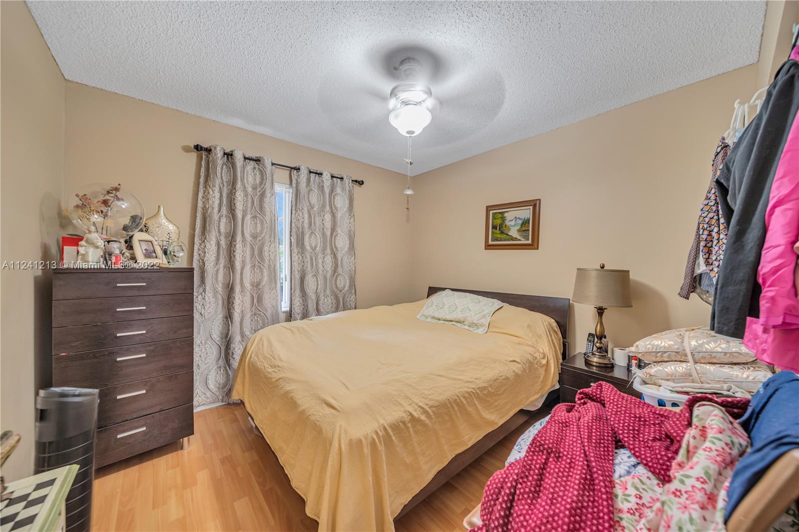 14202 Southwest 151st Court Miami, FL 33196 - Photo 17 of 23 a bedroom with bed and cabinets