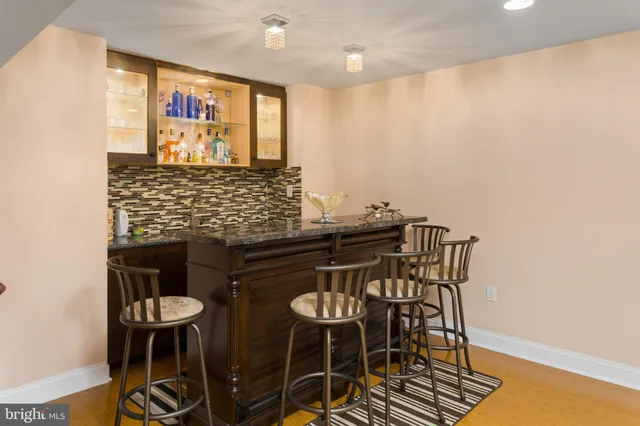 a kitchen with stainless steel appliances a dining table and chairs