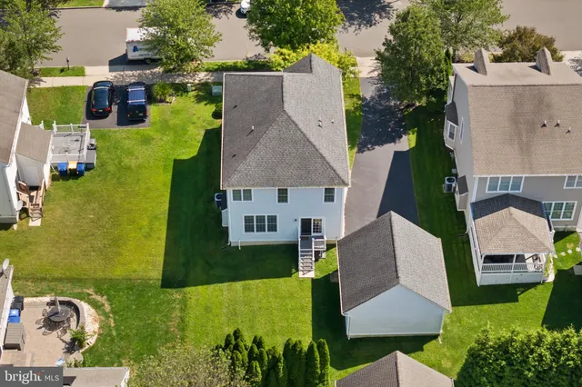 an aerial view of a house with garden space and street view