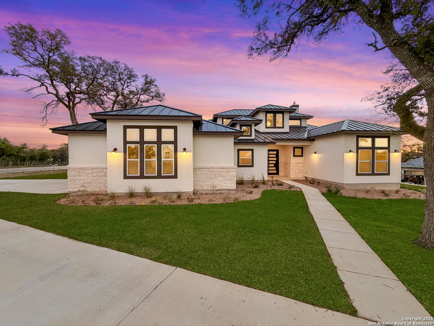 a front view of a house with a garden