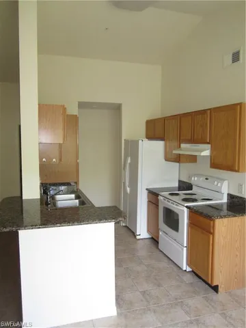 a kitchen with a stove and a refrigerator