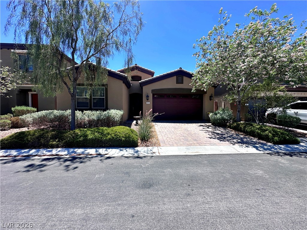 71 Newton Ridge Way Las Vegas, NV 89183 - Photo 1 of 40 A well-maintained facade with mature landscaping provides a welcoming curb appeal.