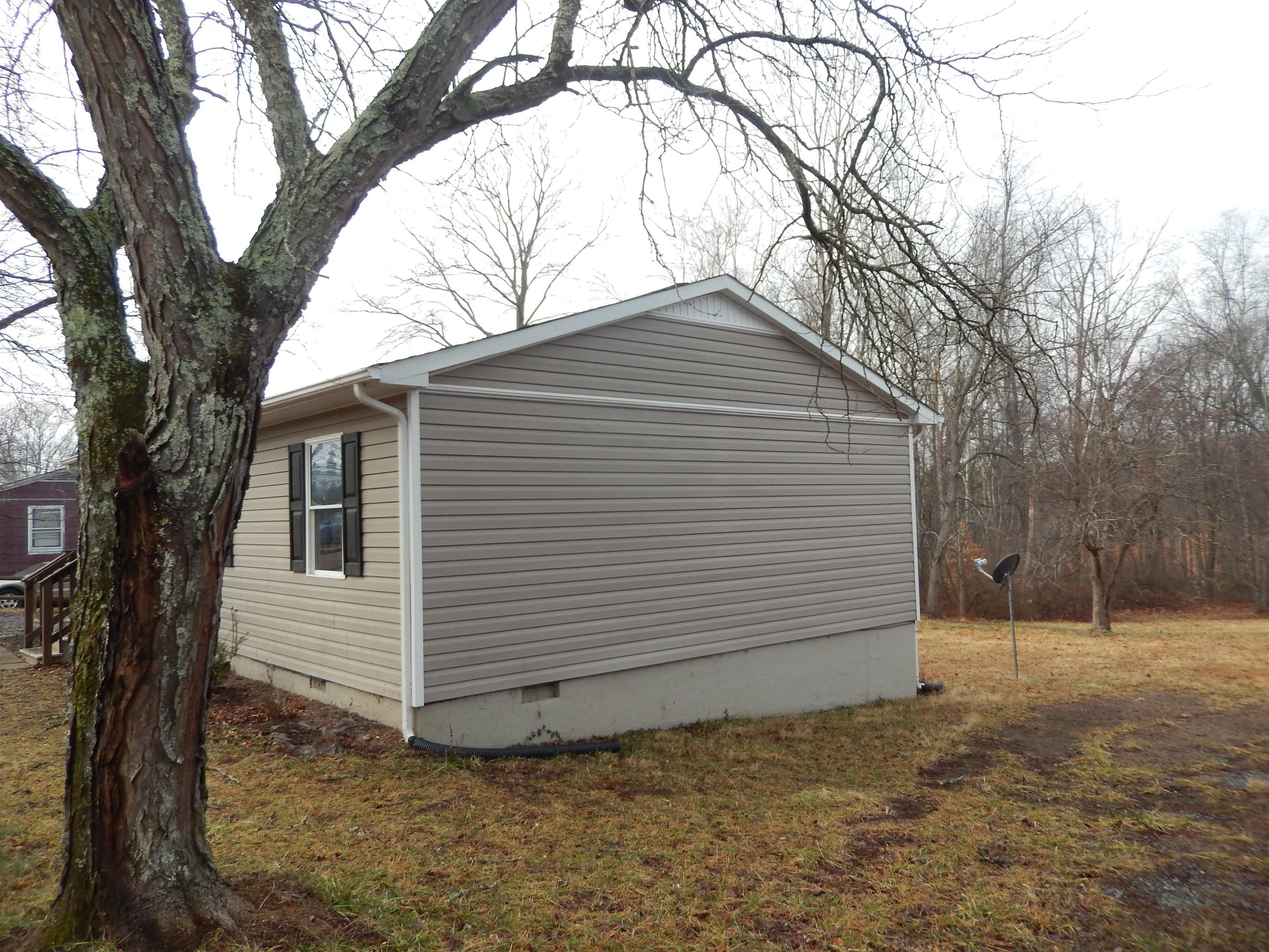 114 Marshall Road Madison, VA 22727 - Photo 16 of 16 a view of a small white house with a large tree