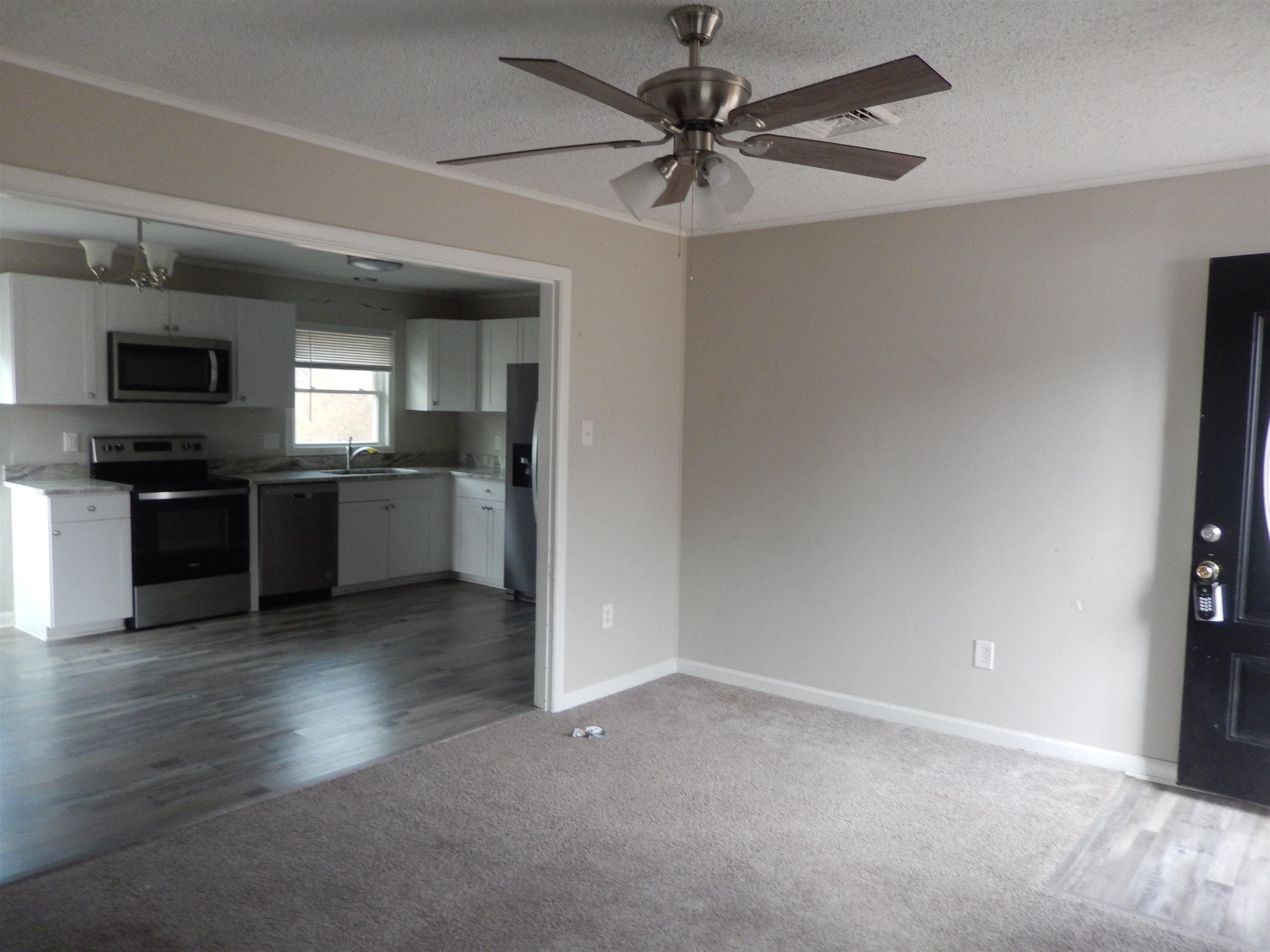114 Marshall Road Madison, VA 22727 - Photo 6 of 16 wooden floor in an empty room with a kitchen
