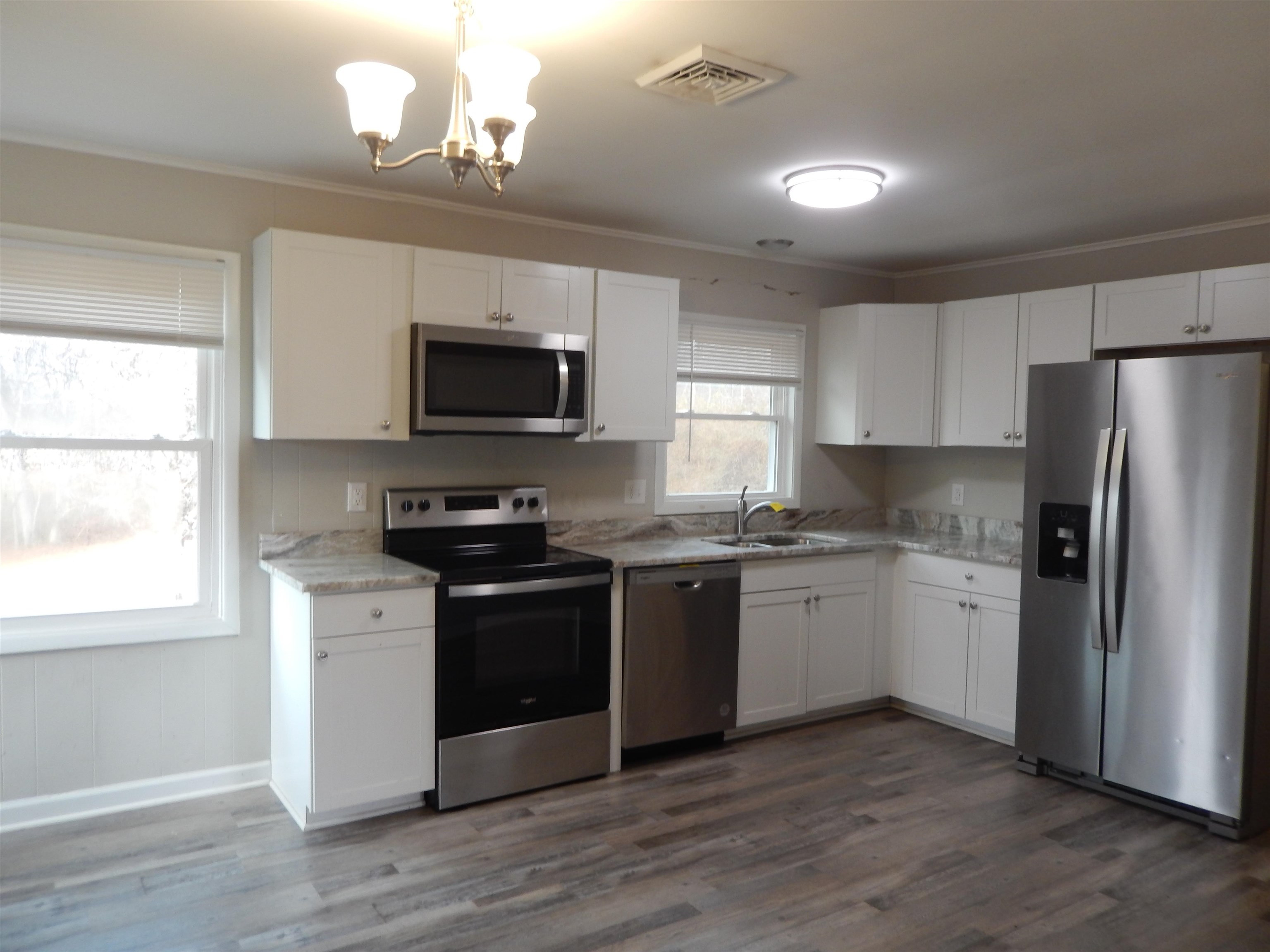 114 Marshall Road Madison, VA 22727 - Photo 7 of 16 a kitchen with stainless steel appliances granite countertop a stove top oven a sink dishwasher a refrigerator and a microwave oven with wooden floor