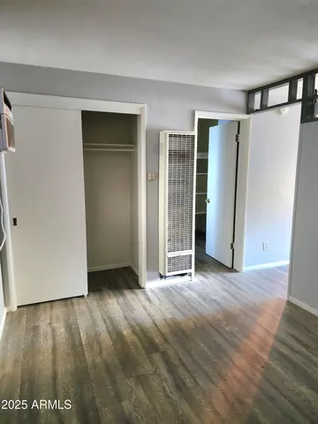 an empty room with wooden floor and a window