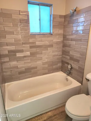 a bathroom with a bathtub and shower