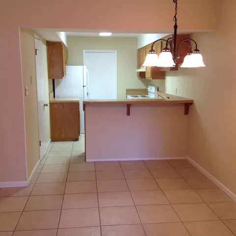 a kitchen with cabinets and window