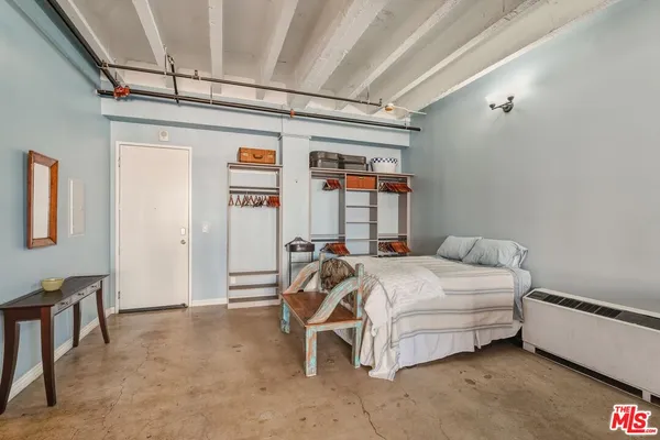 a bedroom with a bed and a cabinets