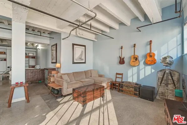 a living room with furniture a rug and white walls