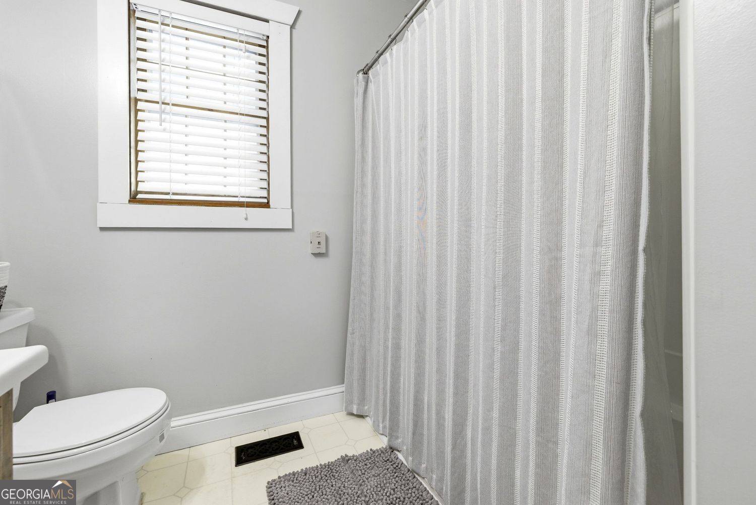 1193 Black Road Cleveland, GA 30528 - Photo 12 of 15 a bathroom with a toilet and a shower curtain