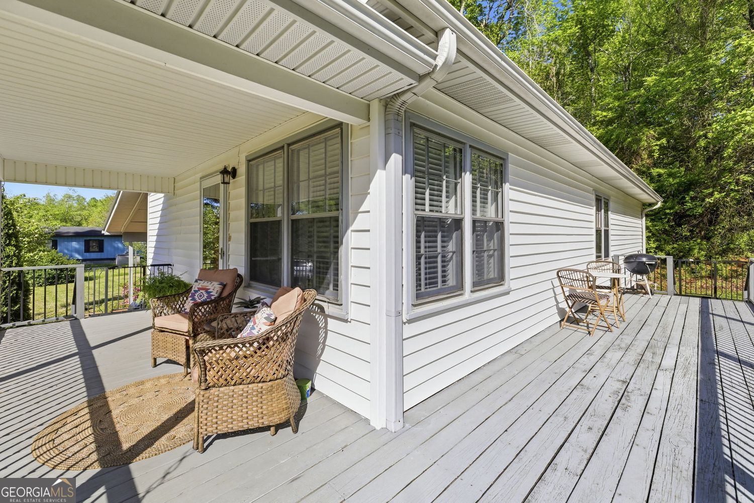 1193 Black Road Cleveland, GA 30528 - Photo 14 of 15 a view of a patio with couches and table and chairs with wooden floor and fence and floor to ceiling window