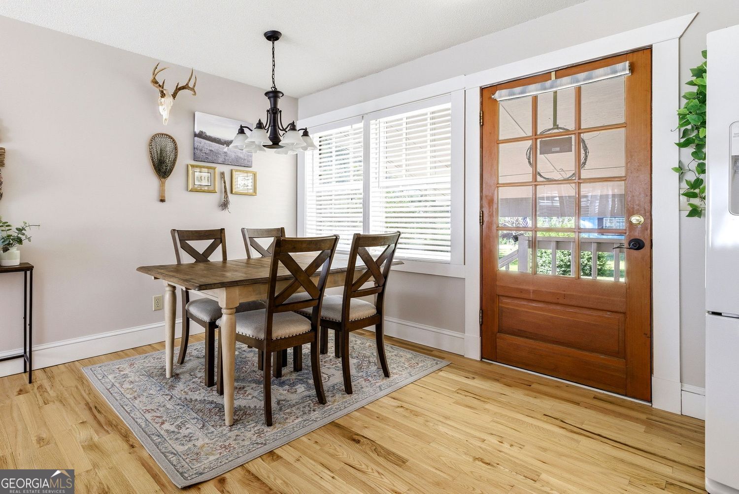 1193 Black Road Cleveland, GA 30528 - Photo 6 of 15 a dining room with wooden floor a chandelier a wooden table and chairs