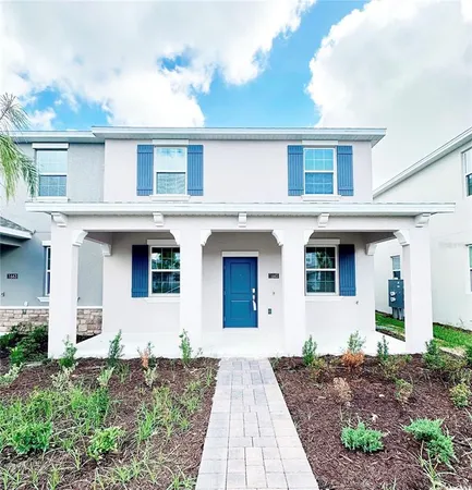 a front view of a house with a yard and a garage