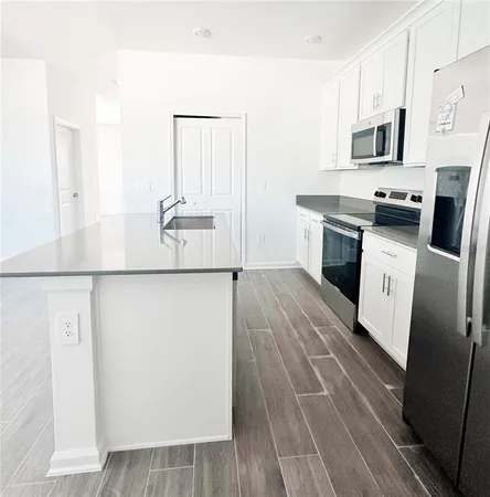 a kitchen with stainless steel appliances a refrigerator stove and sink
